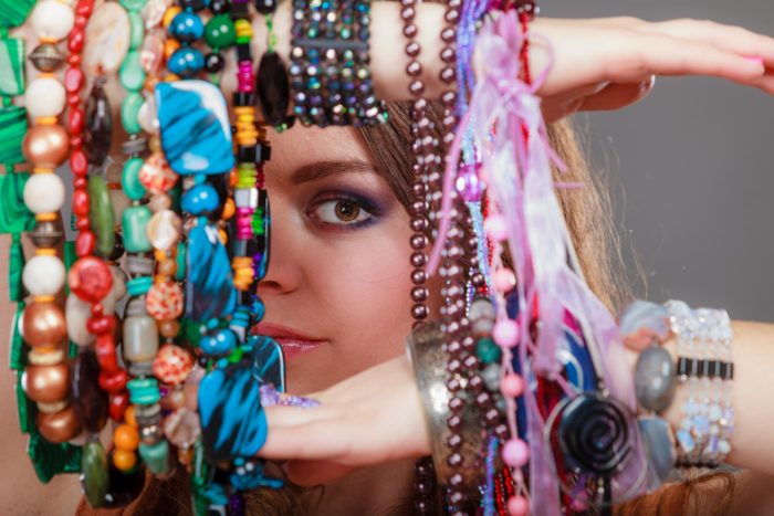 woman holding a bunch of Claire's jewelry