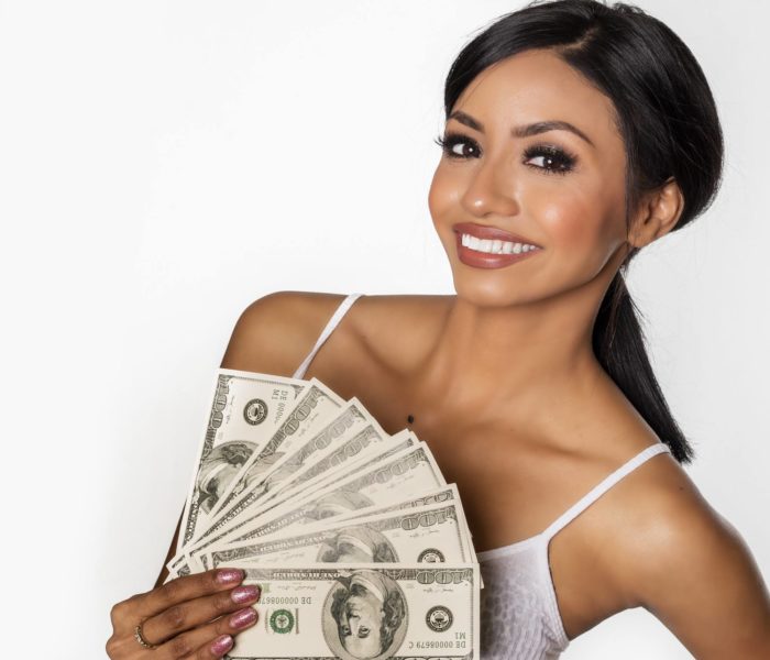 woman holding money from settlement checks