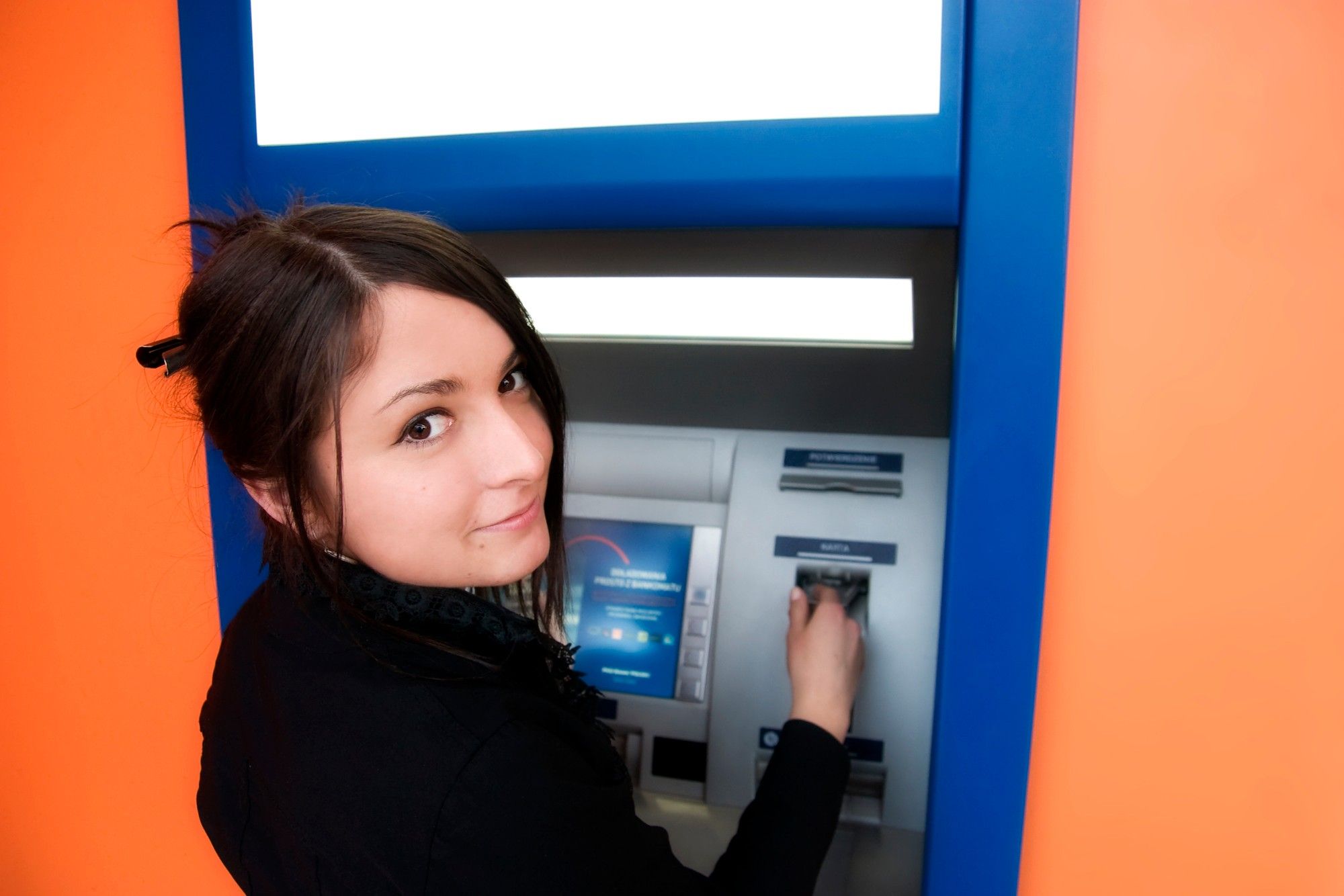 young woman at an ATM machine