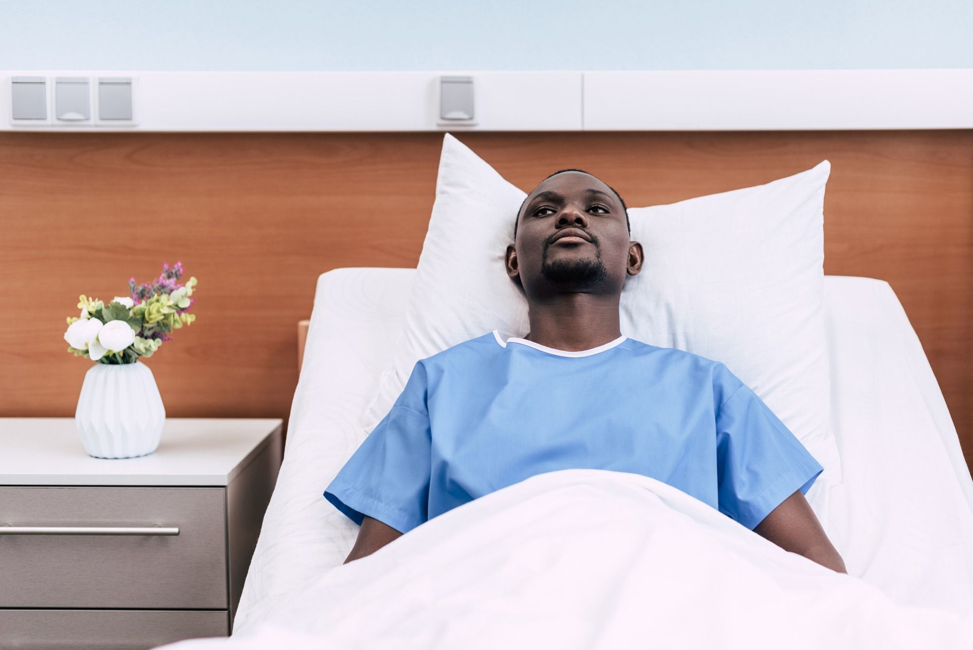 Man laying in hospital bed