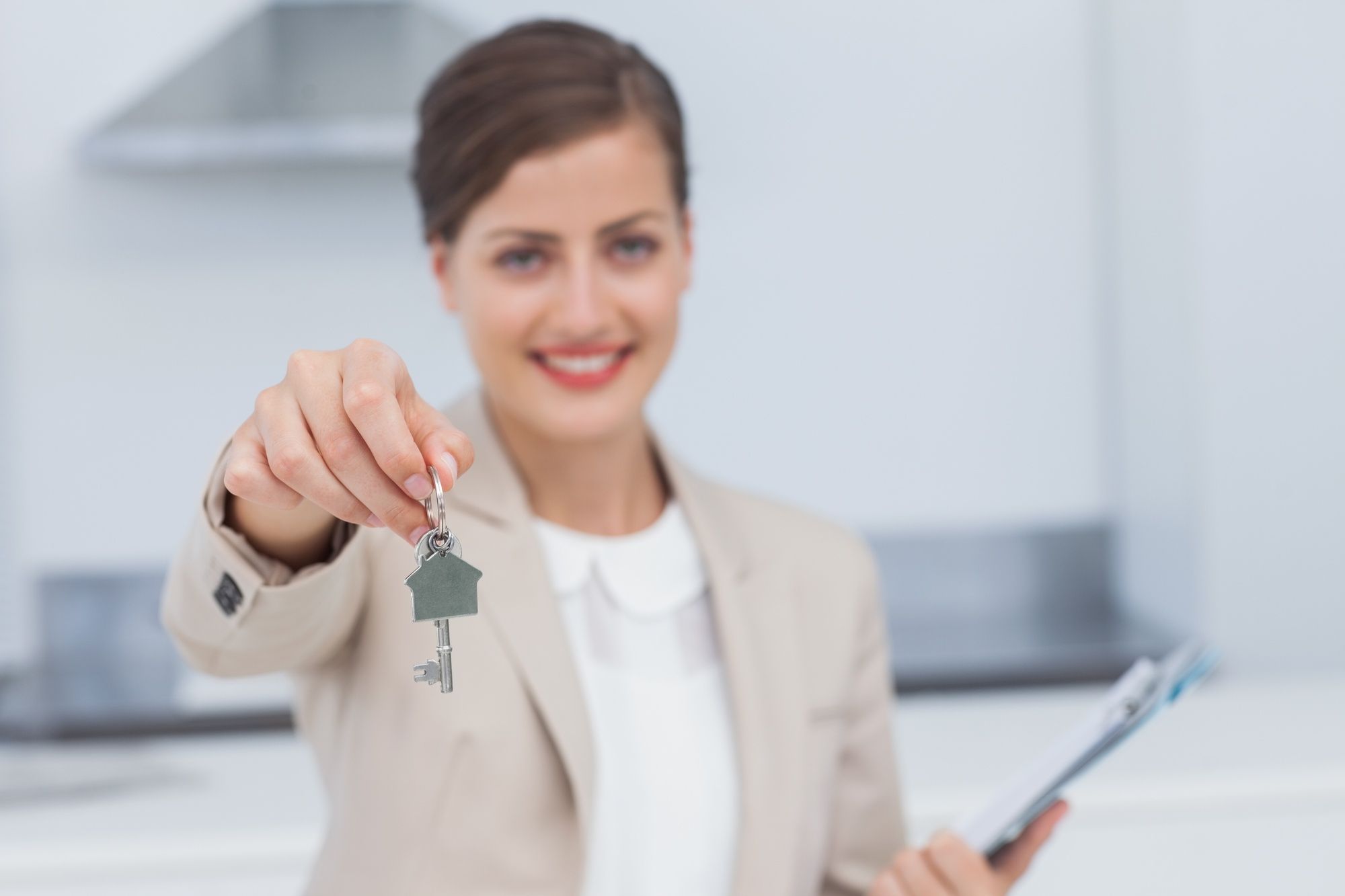 Female real estate agent displays house key