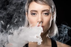Woman blows vaping cloud out her nose