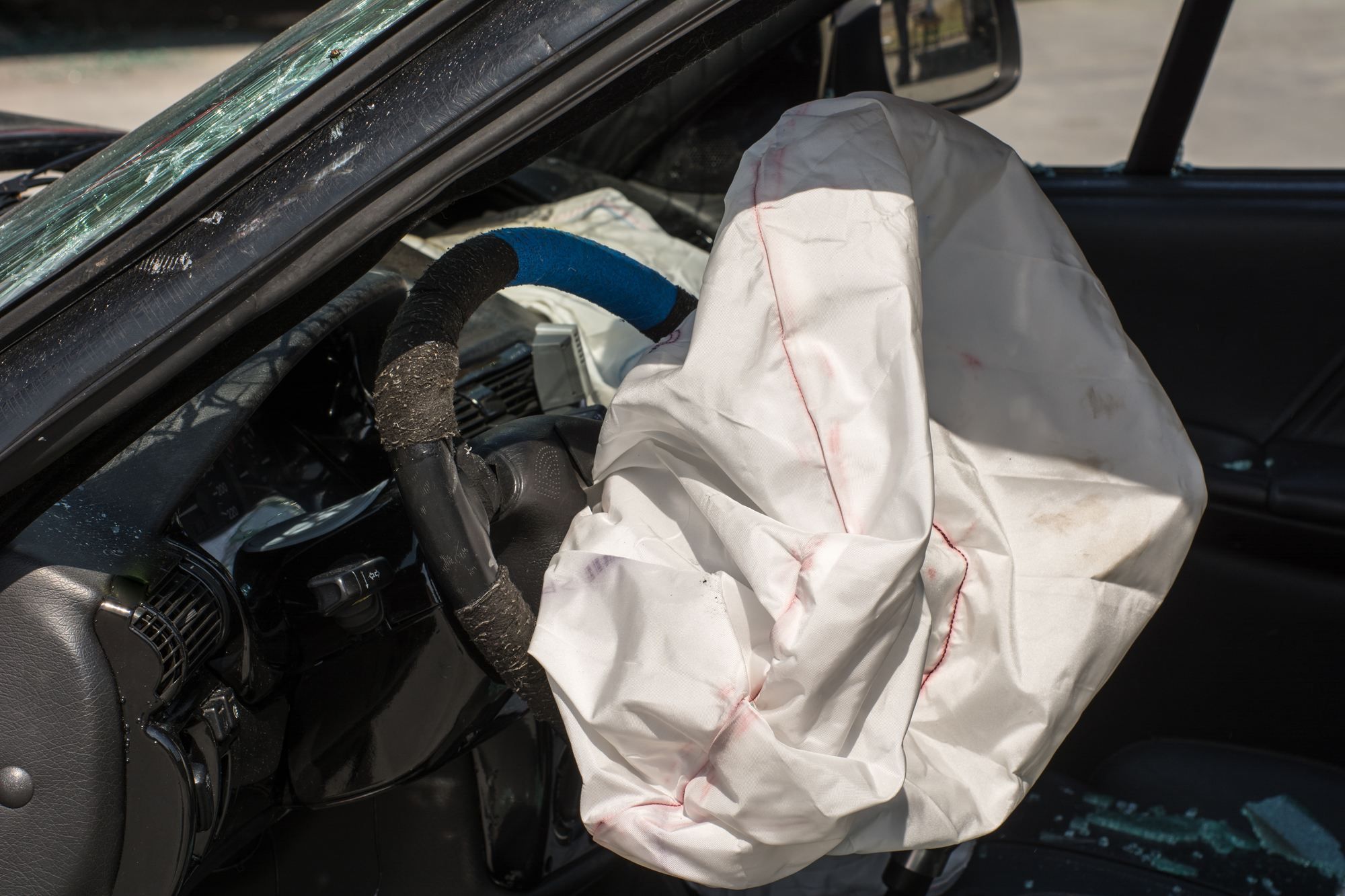 car with exploded airbag after accident