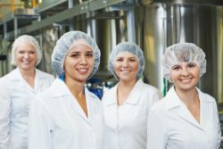 Four factory workers on the job