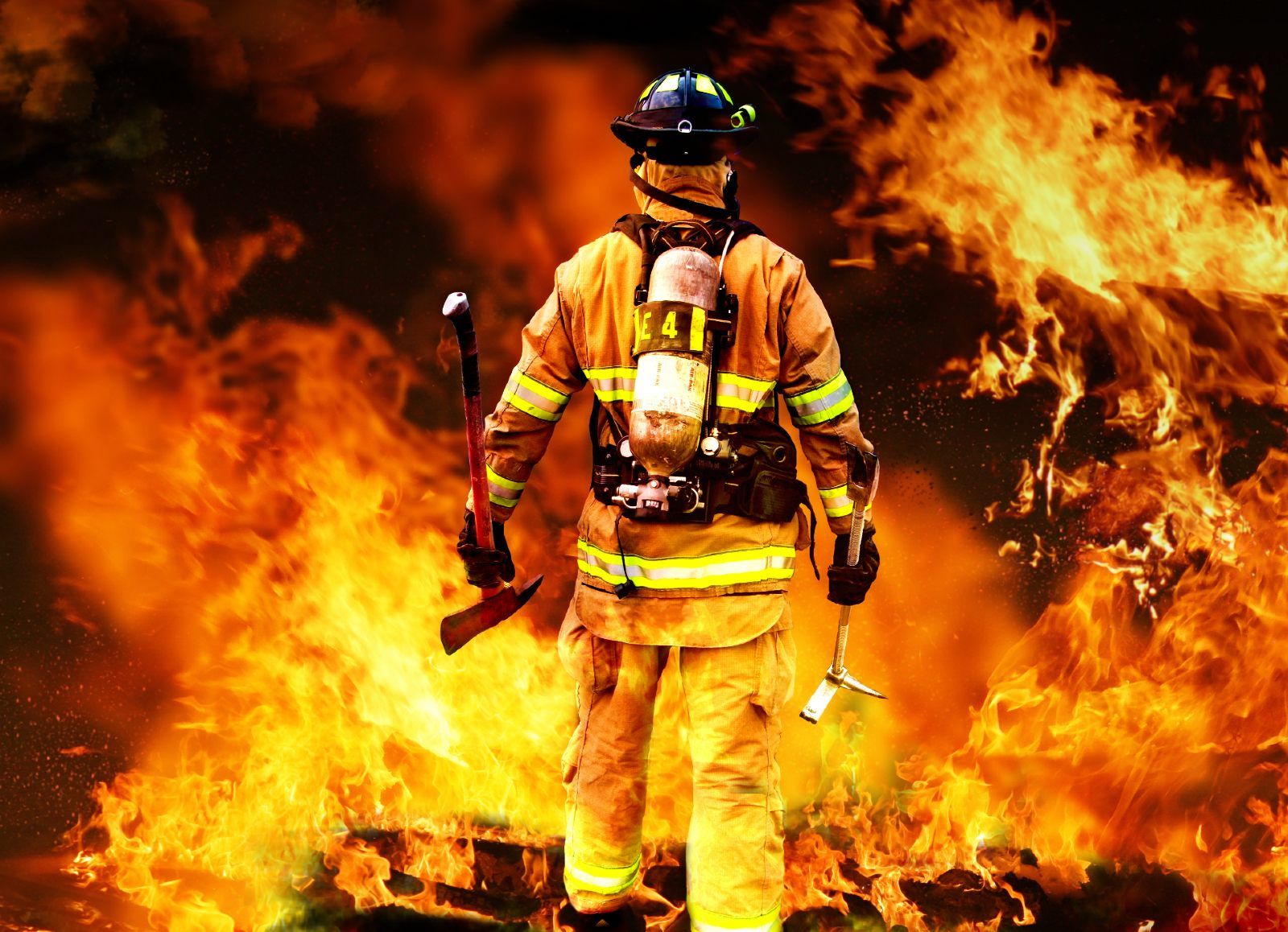 A firefighter is seen from behind walking toward a wall of flame - racial discrimination