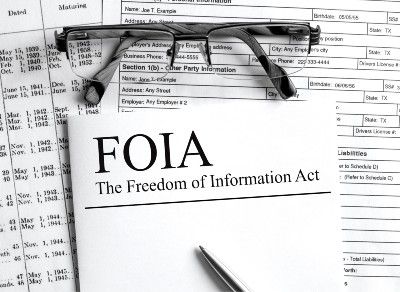 Freedom of Information Act paperwork with a pen and glasses - coronavirus vaccine