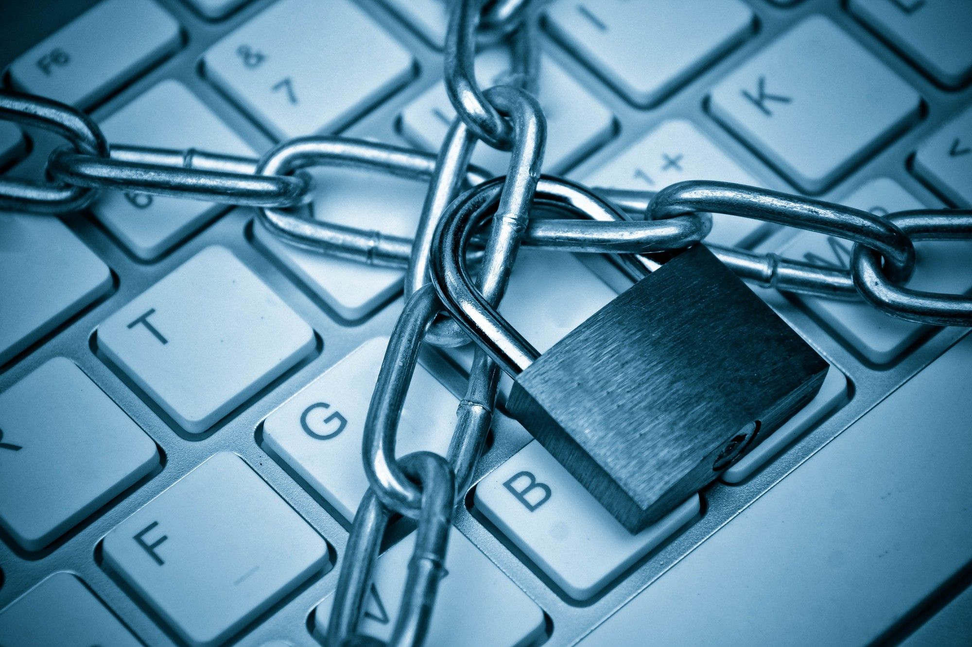Chains locked with a padlock over a computer keyboard - railworks data breach