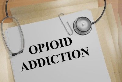 "Opioid addiction" printed on a paper in a folder lying with a stethoscope - Perdue Pharma