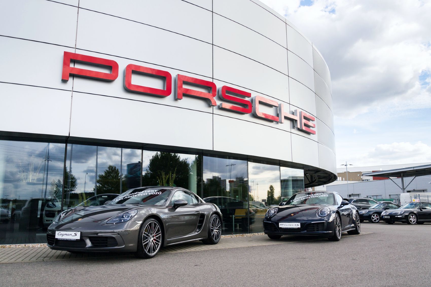 Porsche dealership under partly cloudy sky - porsche emissions