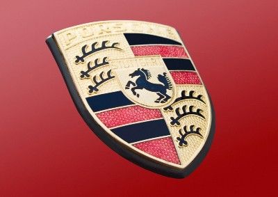 Porsche emblem on red background - porsche emissions