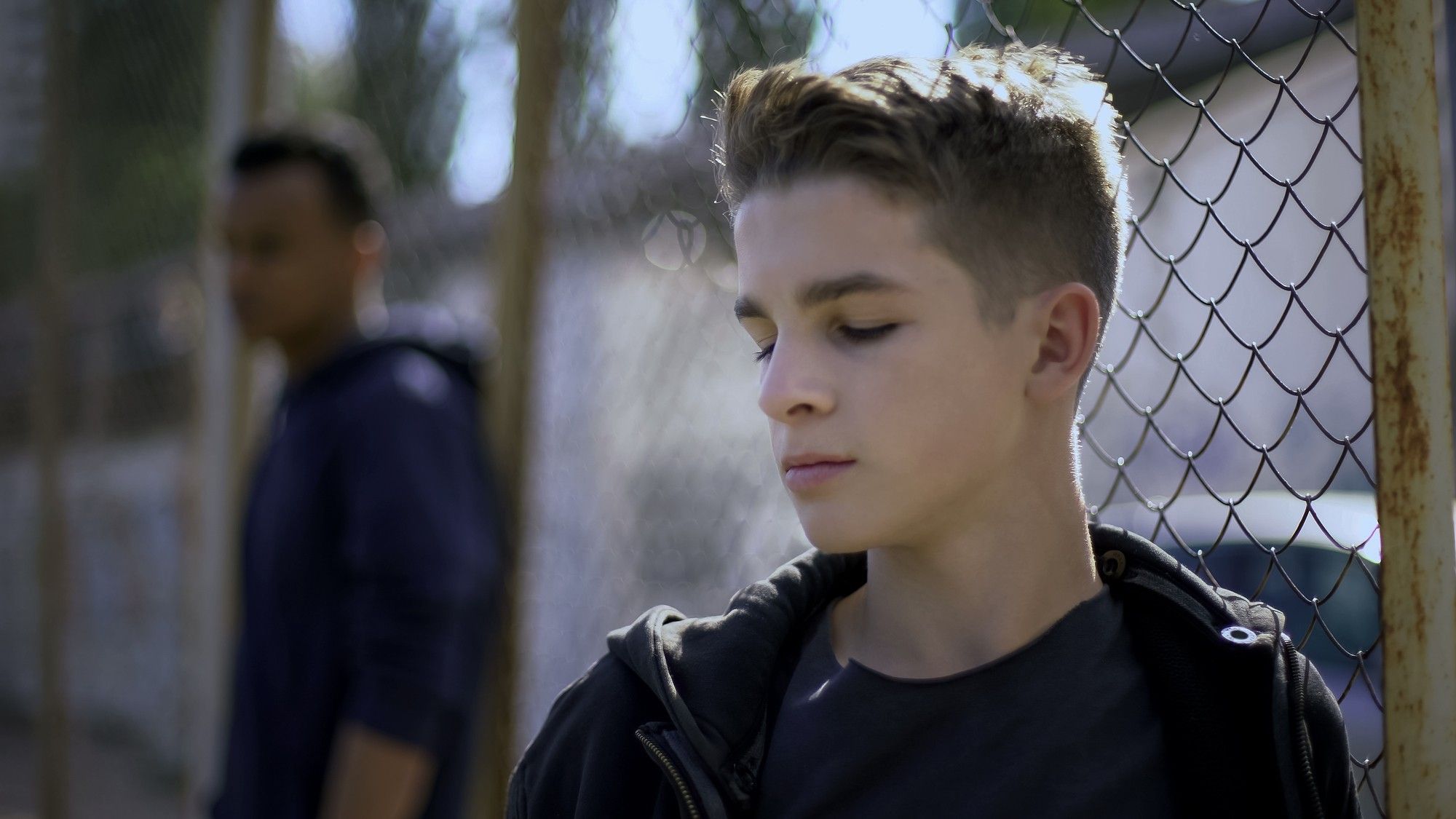 teen boy in detention center yard