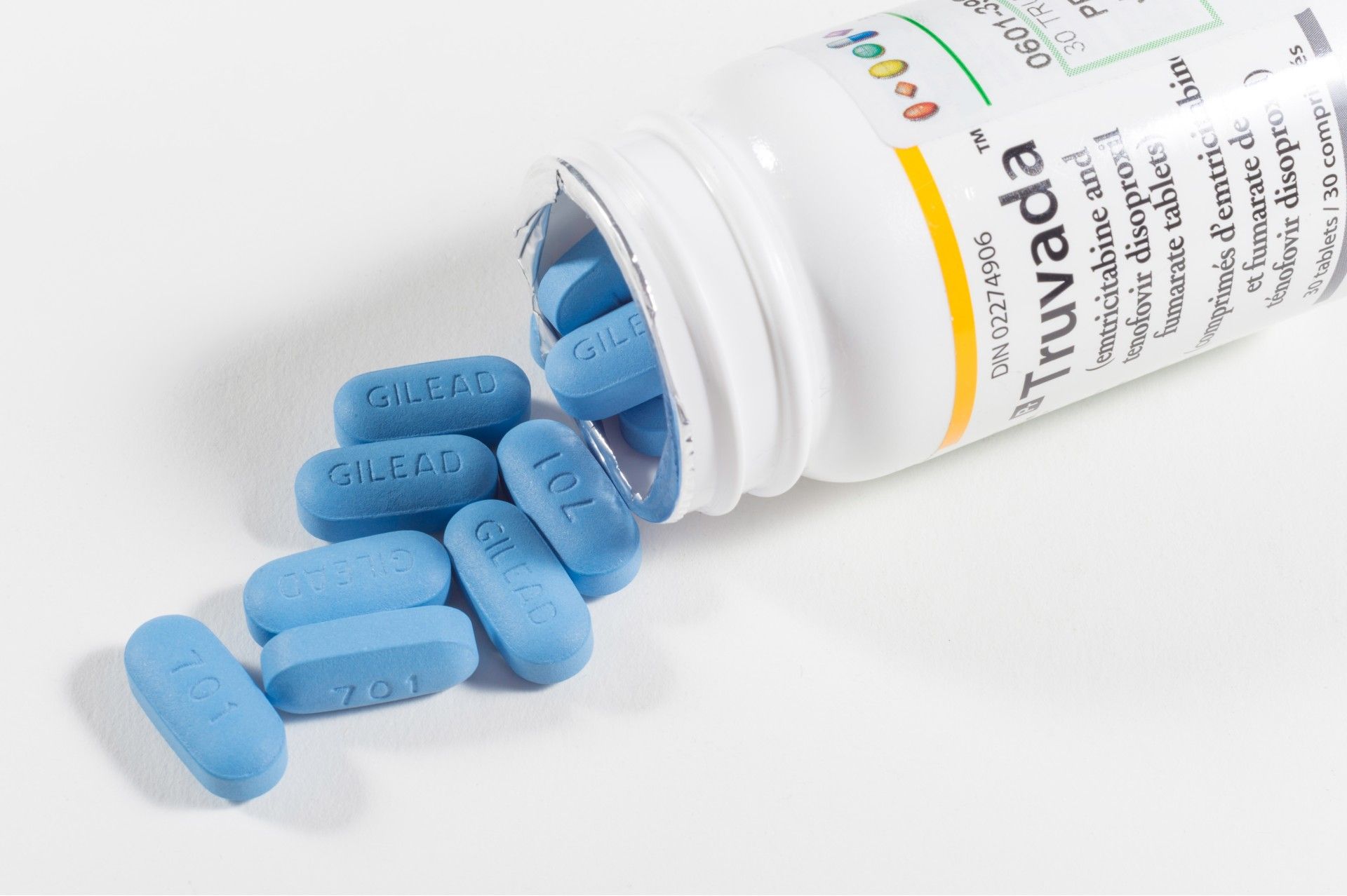 Bottle of Truvada lying on its side with pills spilling out - hiv meds