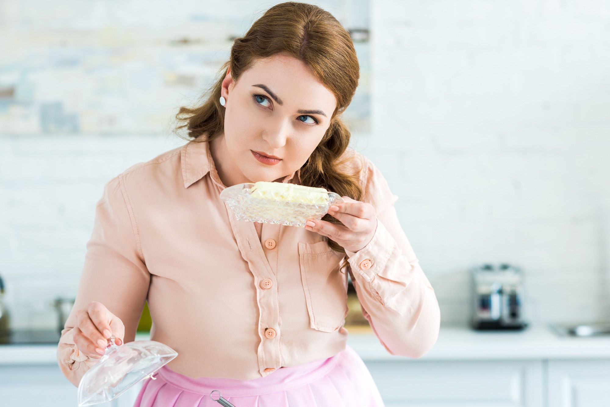 Woman inspecting butter regarding the Entenmann's All Butter Loaf Cake class action lawsuit