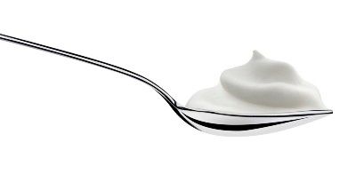 A spoon full of white yogurt - chobani greek yogurt