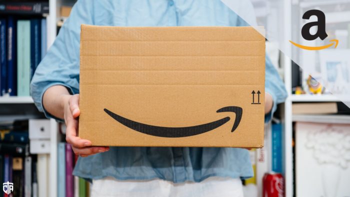 person holding Amazon shipping box