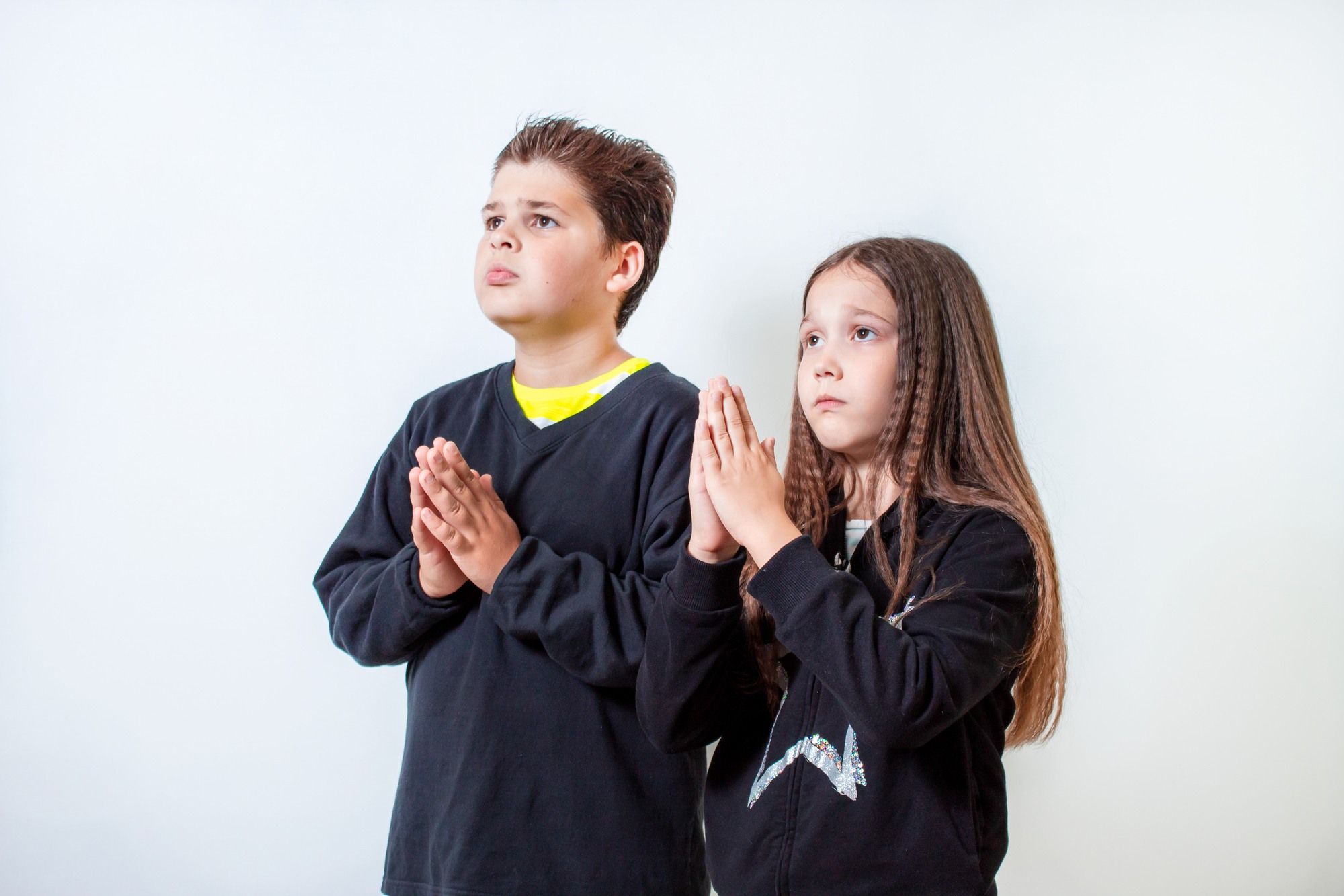 Little boy and girl praying