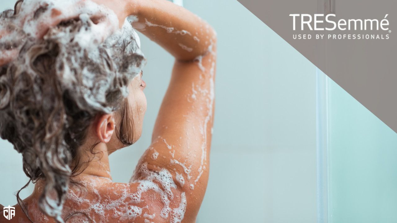 A woman shampoos her hair while showering - hair loss
