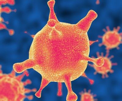 Red-and-orange coronaviruses against blue background - coronavirus cure
