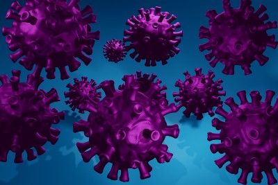 Purple coronaviruses on a blue background - COVID-19 pandemic