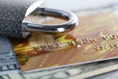 A padlock lies on top of some cash and a credit card - data breach