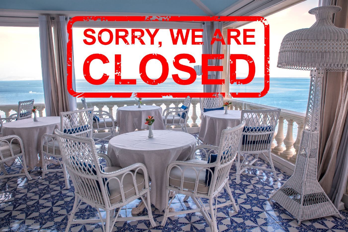 An open-air restaurant by the ocean with a stamp over the photo that reads "sorry, we're closed" in red - bars in Hawaii