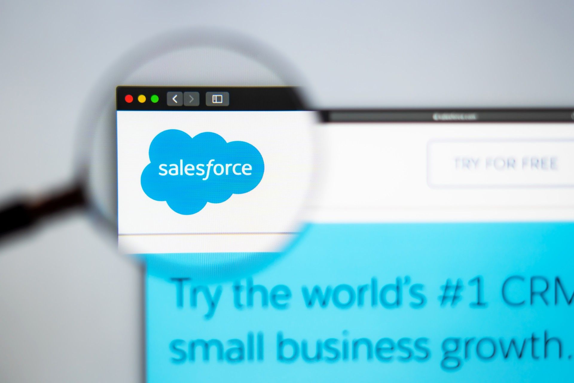 A magnifying glass magnifies the Salesforce logo on the company's website - data breach