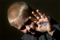 Abused boy has the word stop written on his palm