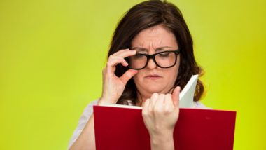 Woman having trouble reading words in book