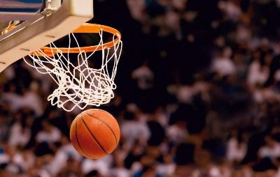 A basketball falls through a hoop - racial bias