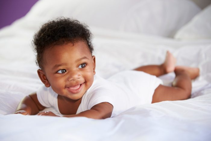 infant on bed after taking Little Remedies pain reliever