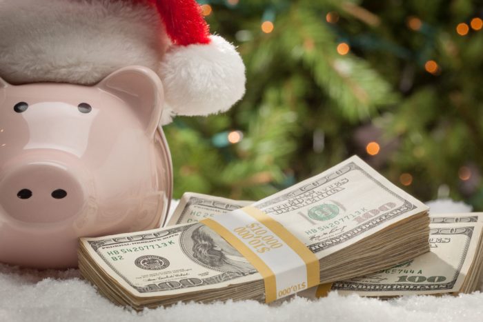 class action rebates cash next to piggy bank wearing a Santa hat