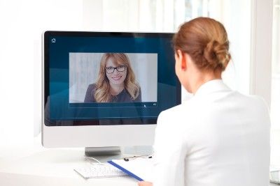 Two women have a one-on-one video chat via computer - Zoom privacy