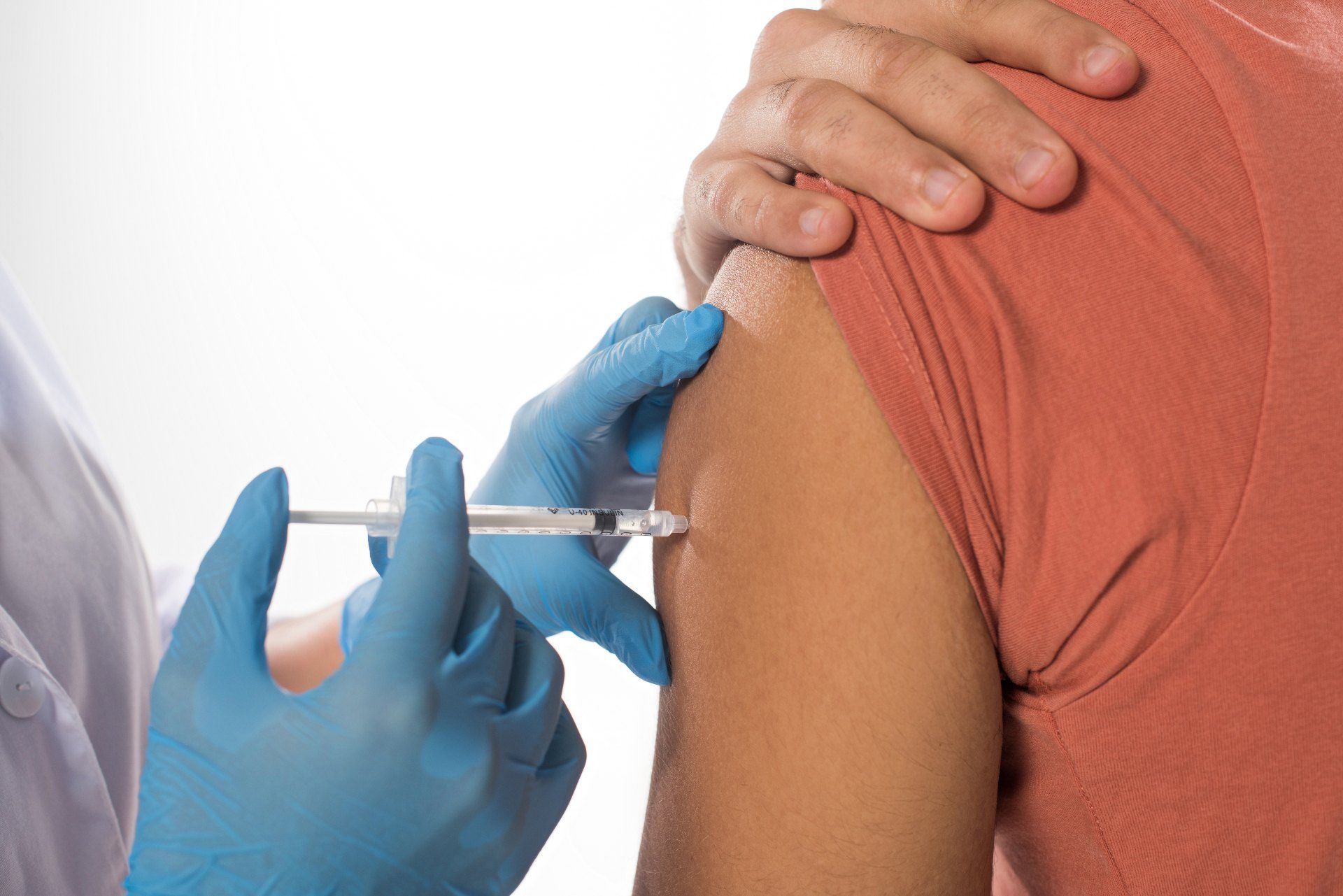 A person receives a vaccination in the arm - coronavirus vaccine