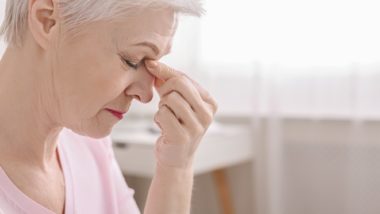 Elderly woman suffering headache from vision difficulty