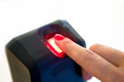 A woman scans her index finger on a fingerprint scanner - Navy Pier