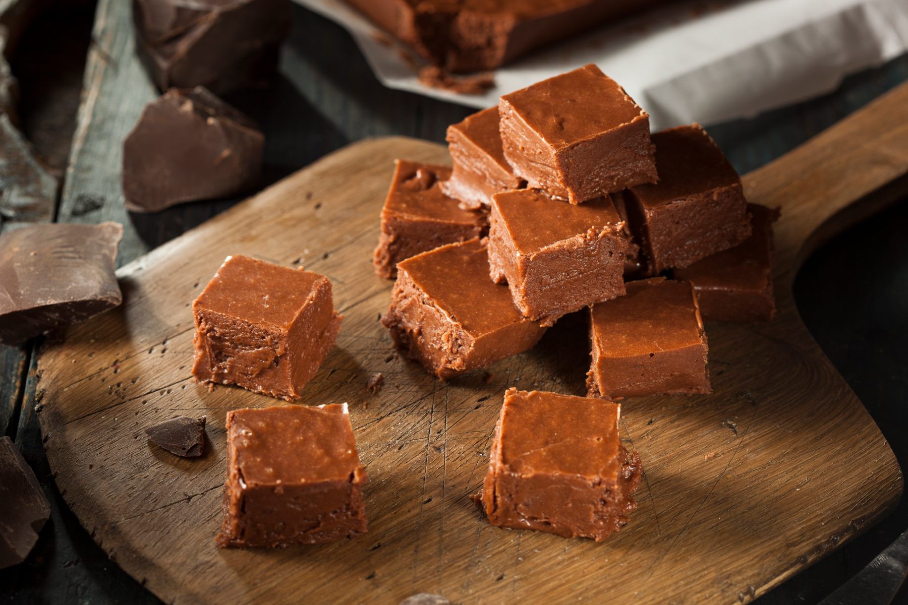 Cubes of fudge sit on a wooden cutting board - Keebler fudge