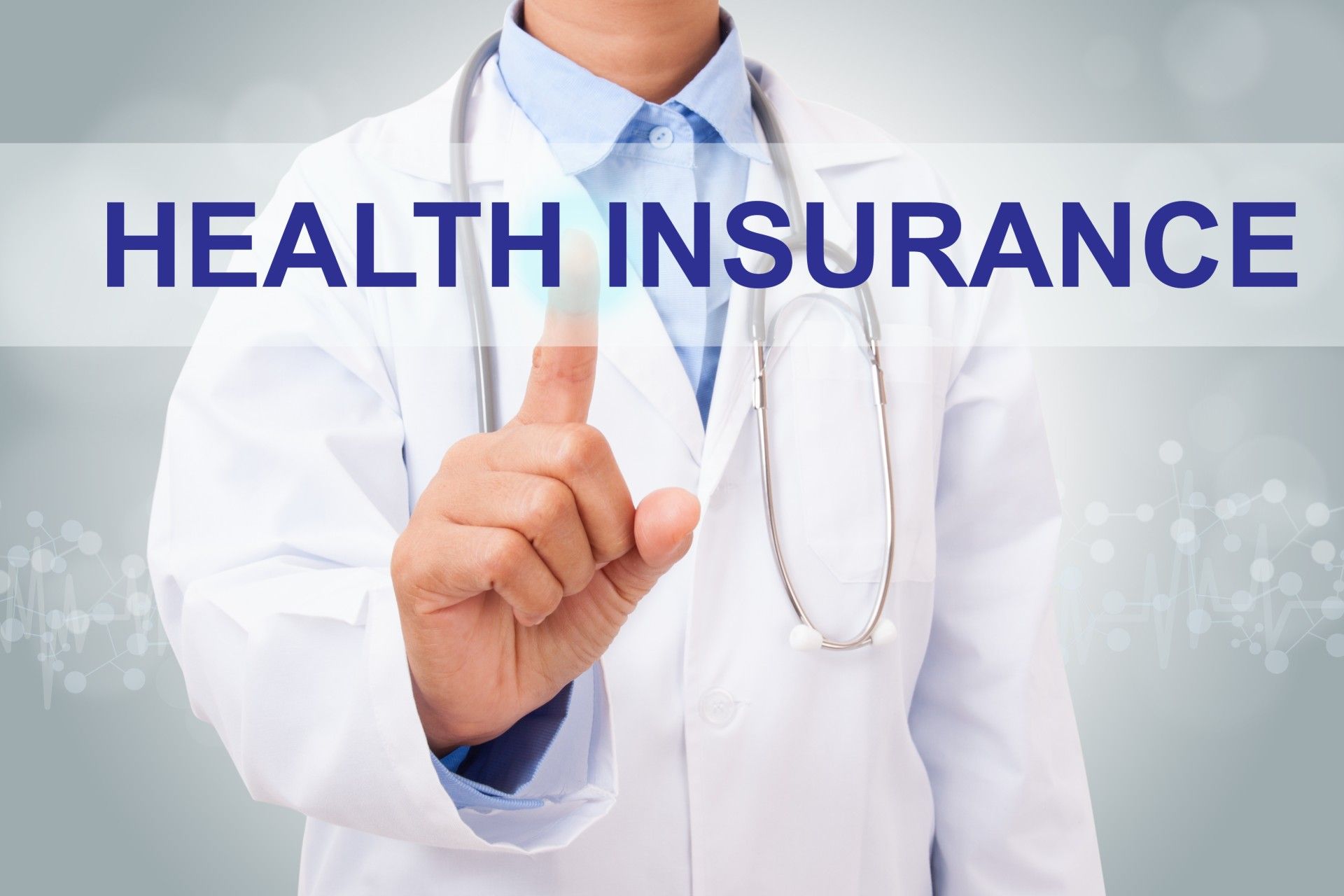A doctor with a stethoscope around his neck points at a "health insurance" graphic in front of him