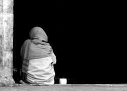 Homeless woman sitting alone
