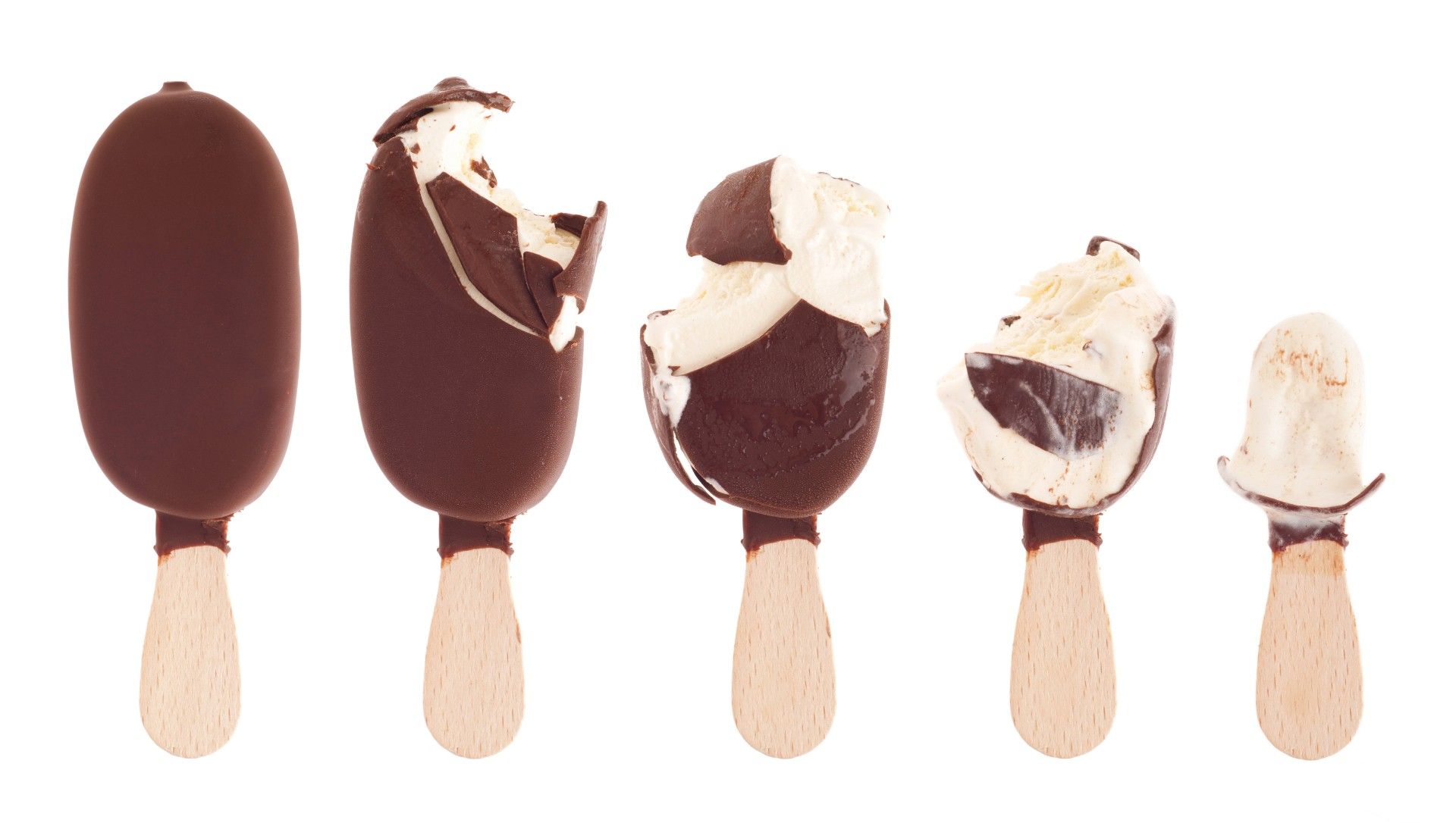 Chocolate-covered vanilla ice cream bars in various states of being eaten - milk chocolate