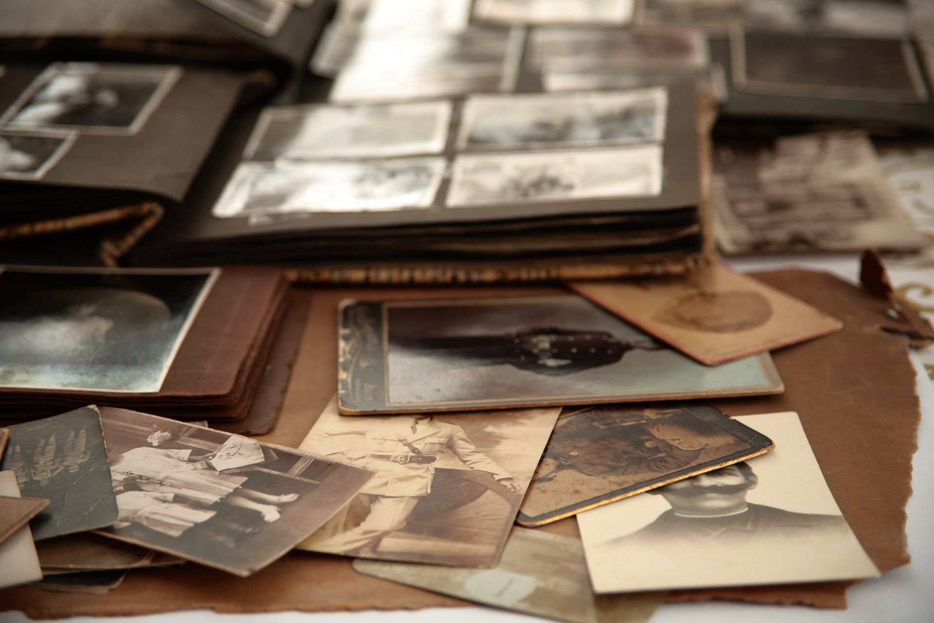 Old photos and photo albums are spread out on a table