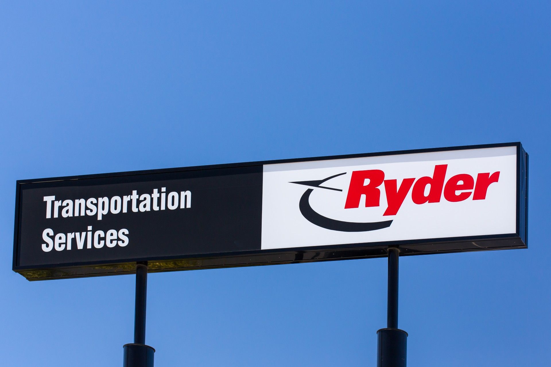 Ryder Transportation Services sign against a blue sky - delivery drivers