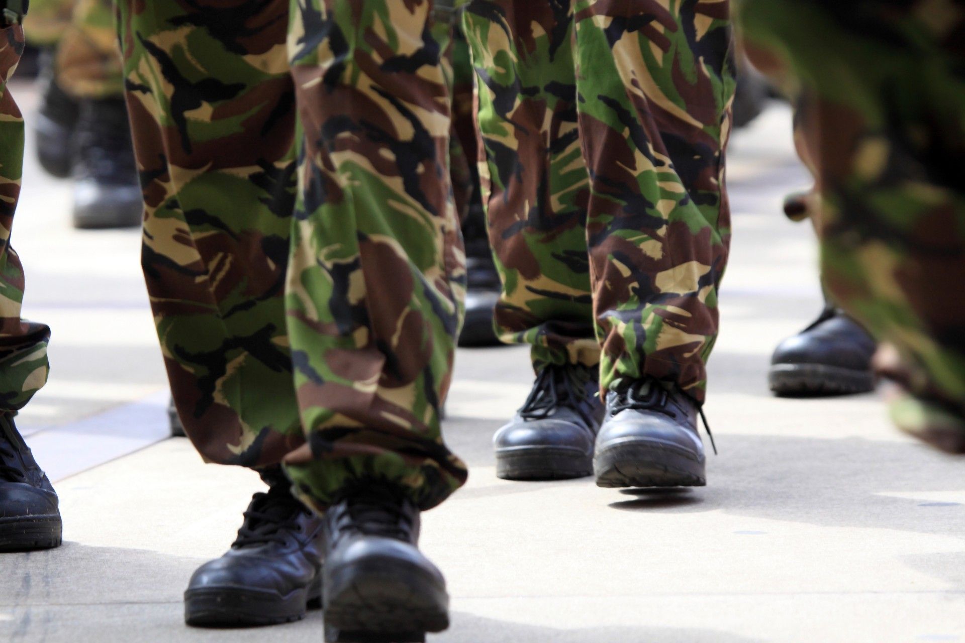 Closeup of legs marching while in BDUs and combat boots - military leave