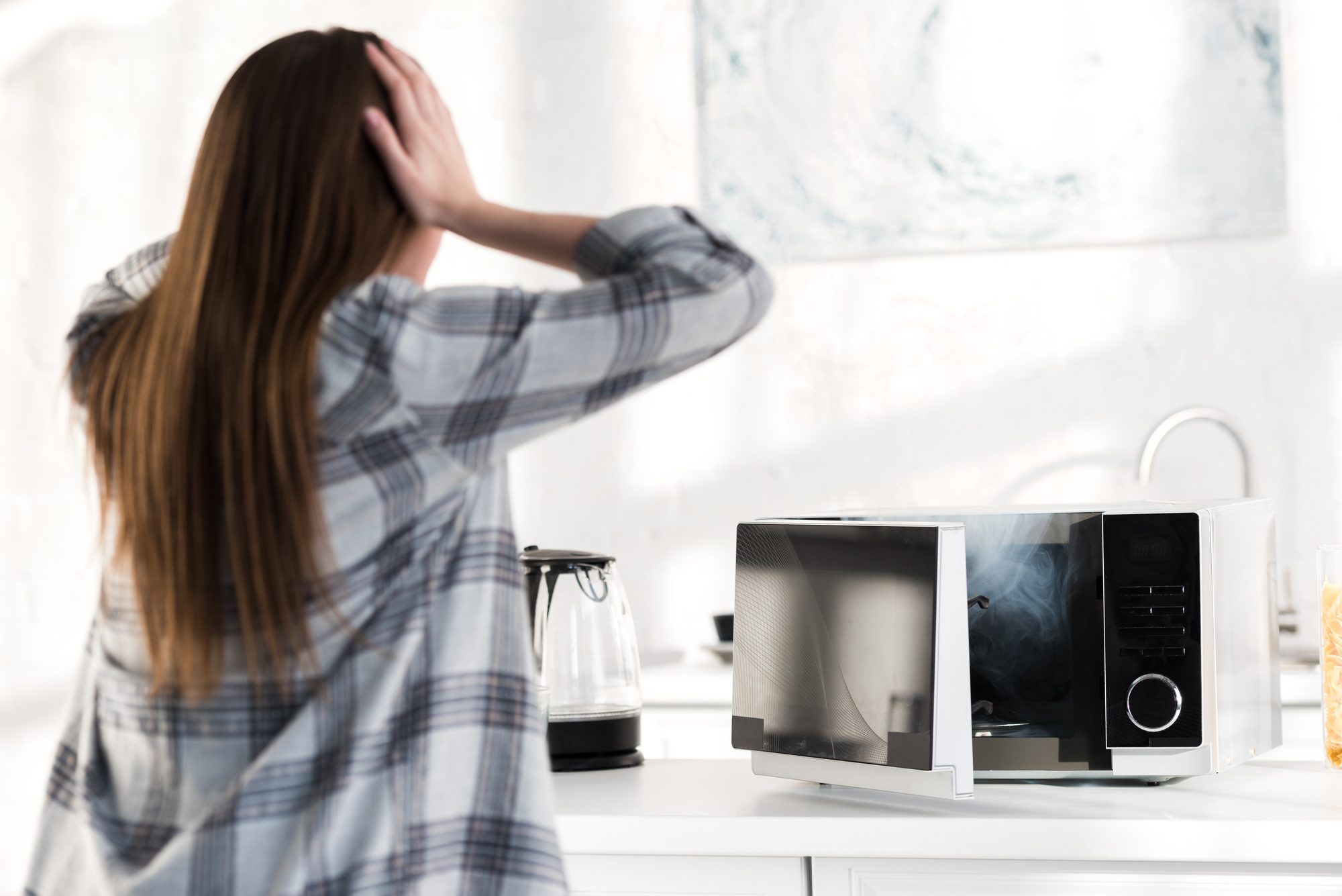 Woman with a broken Sharp Microwave.