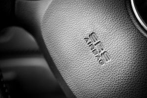 A black steering wheel reads "SRS airbag" - Takata airbag
