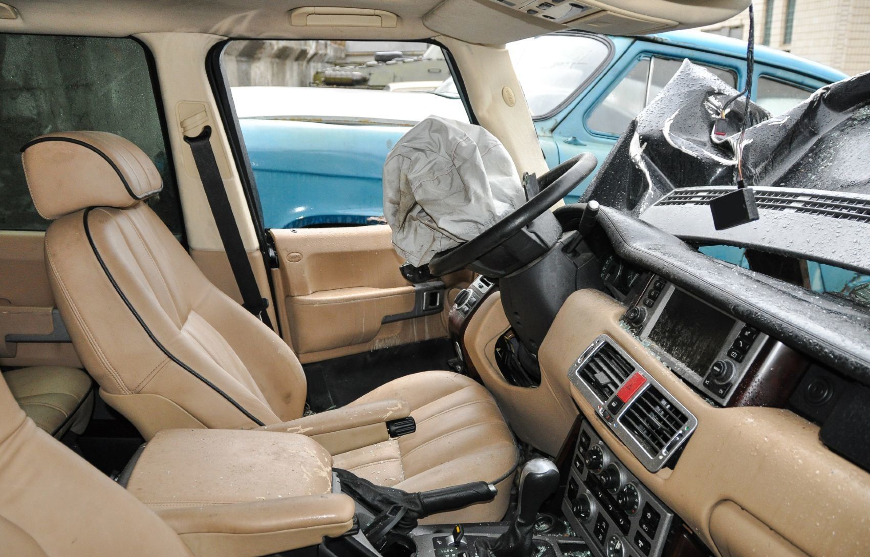 The interior of a car is seen after an accident. The driver's-side airbag has been deployed - takata airbag