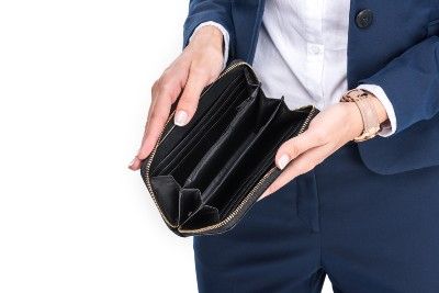 A person holds an empty wallet open - Oregon unemployment