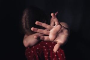 Girl hides her face and holds her palm up to the camera - Boys & Girls Club of America