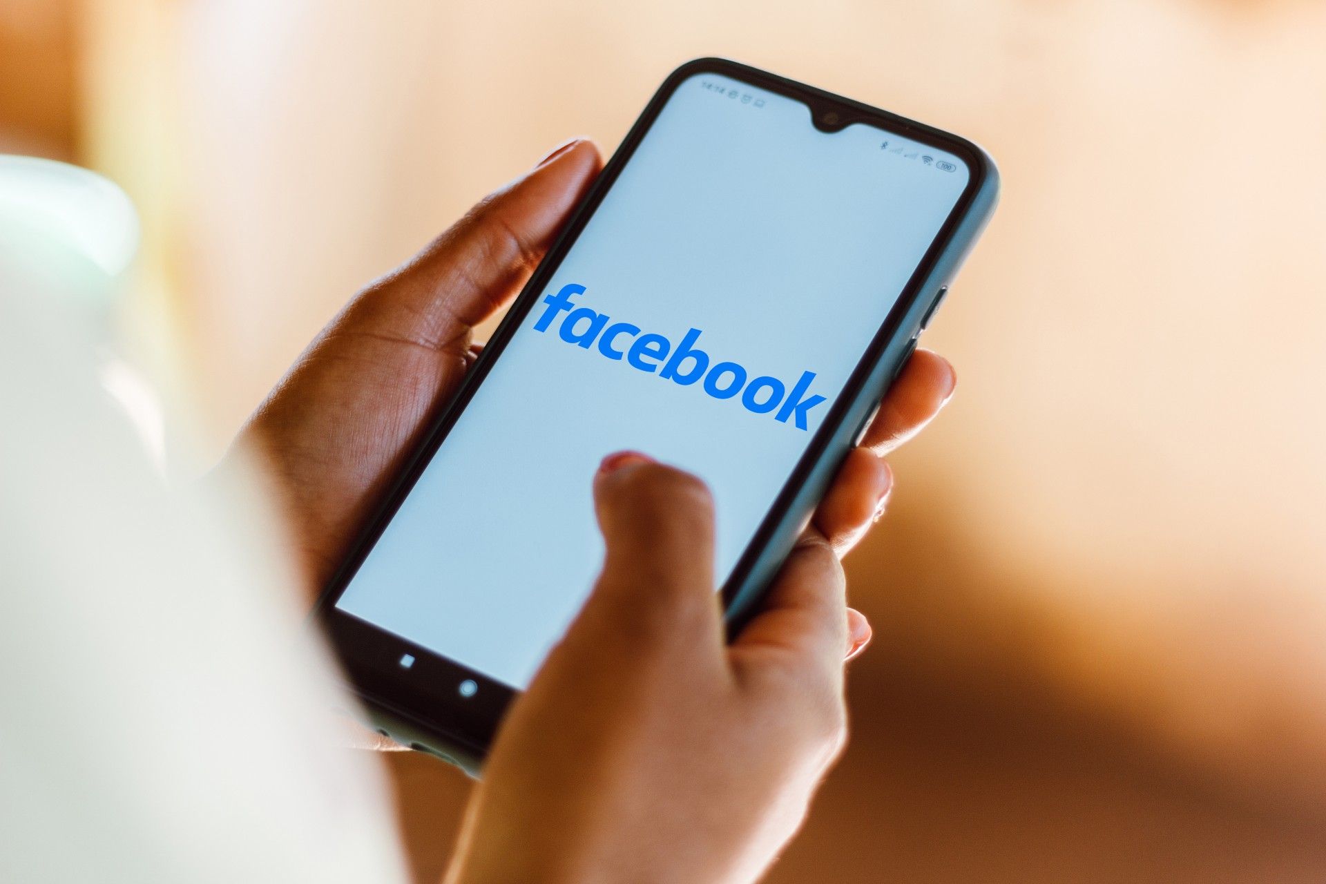 Closeup of the Facebook loading screen on a smartphone in someone's hands - data privacy