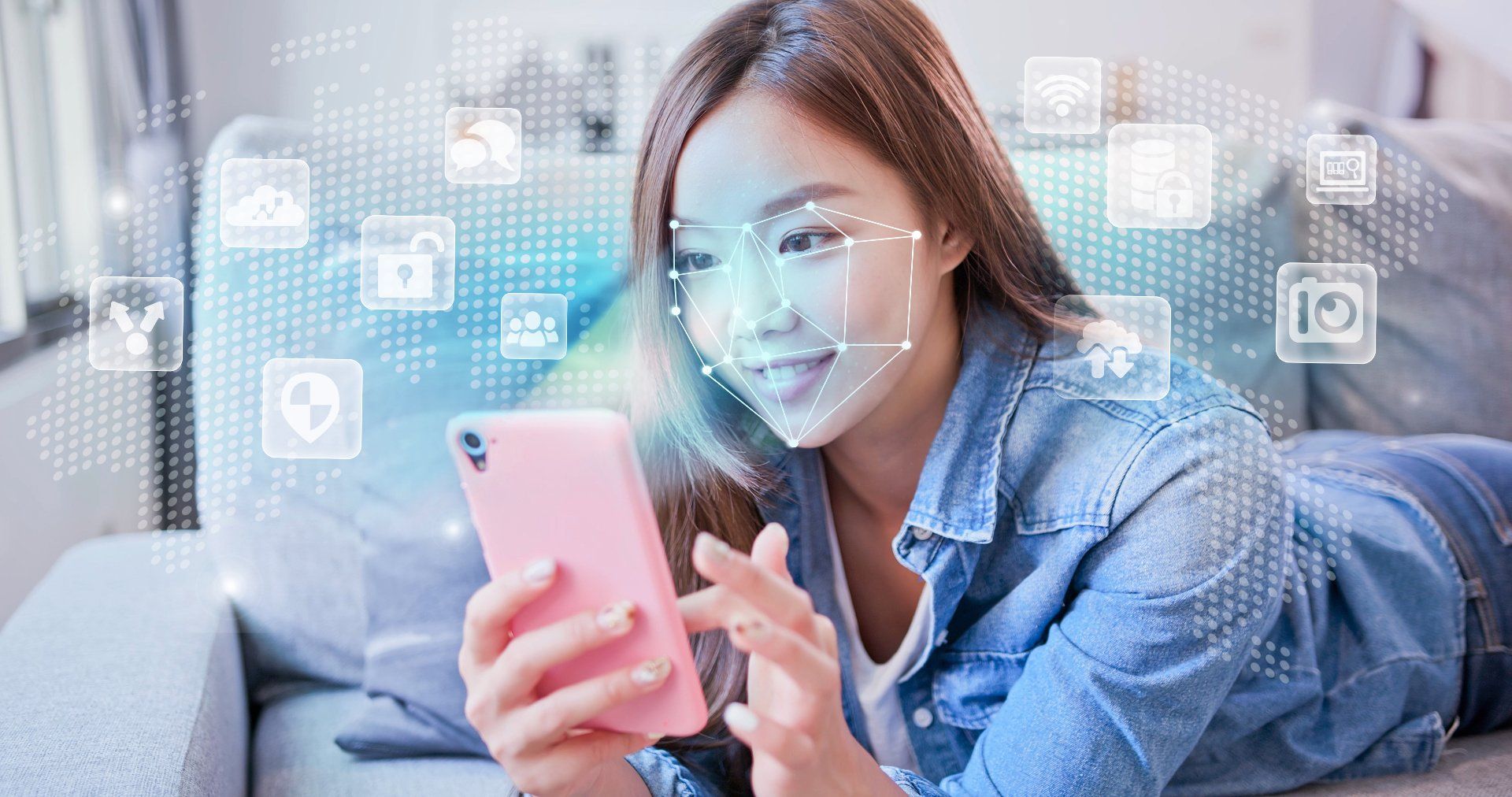 A young woman holds a smartphone as a graphic around her face shows facial recognition software is in use - data privacy