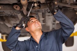 auto mechanic working on suspension system